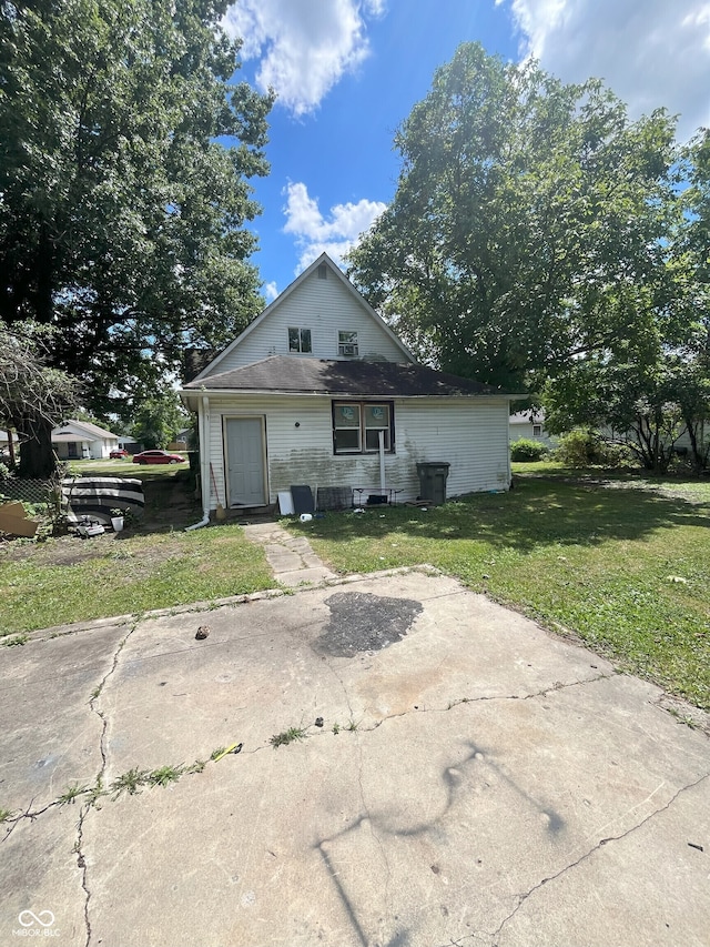 rear view of house with a yard