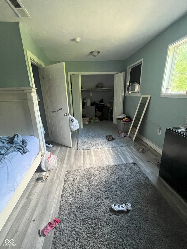 unfurnished bedroom featuring wood-type flooring and a closet