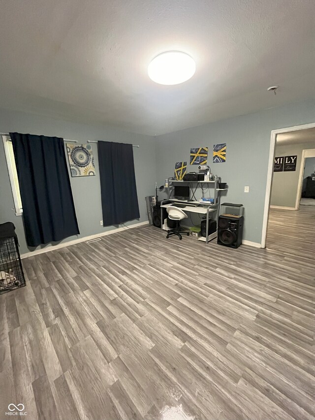 office area with wood-type flooring and a textured ceiling