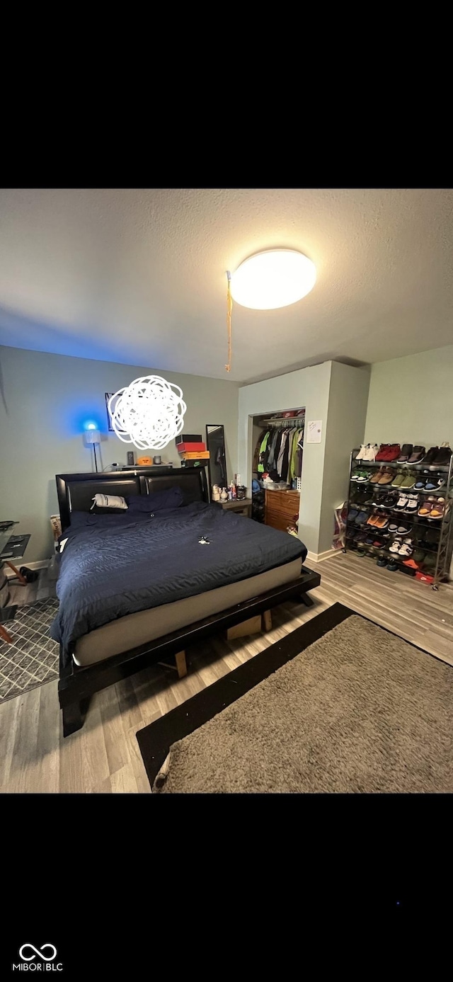 bedroom featuring wood-type flooring and a textured ceiling