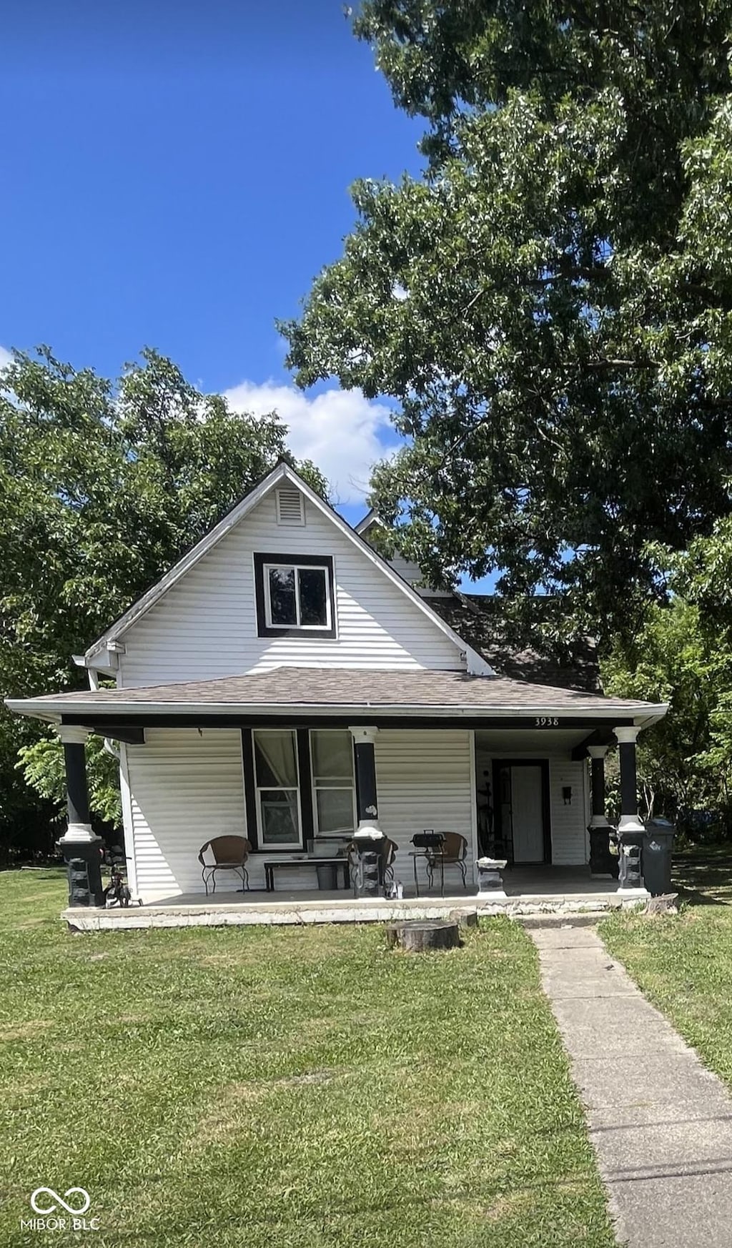 view of front of property with covered porch and a front yard