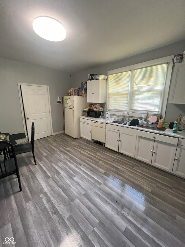 kitchen featuring white appliances, light hardwood / wood-style floors, and white cabinetry