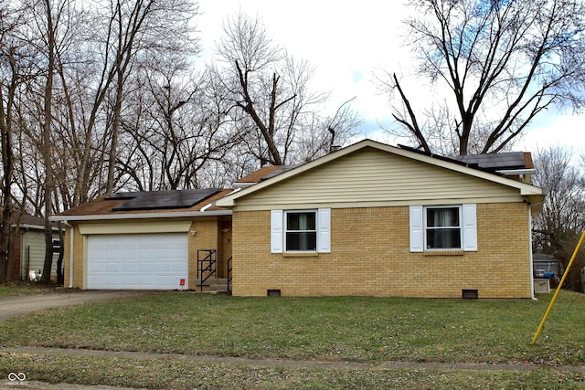 view of front of property with a front yard, solar panels, and a garage