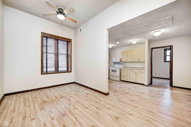 unfurnished living room featuring ceiling fan, light hardwood / wood-style floors, and a textured ceiling