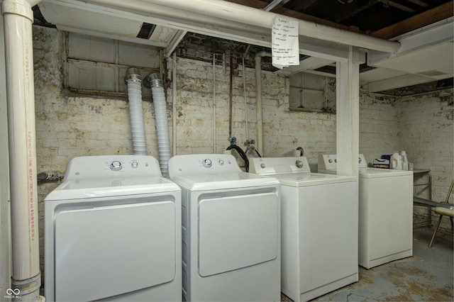 clothes washing area featuring independent washer and dryer