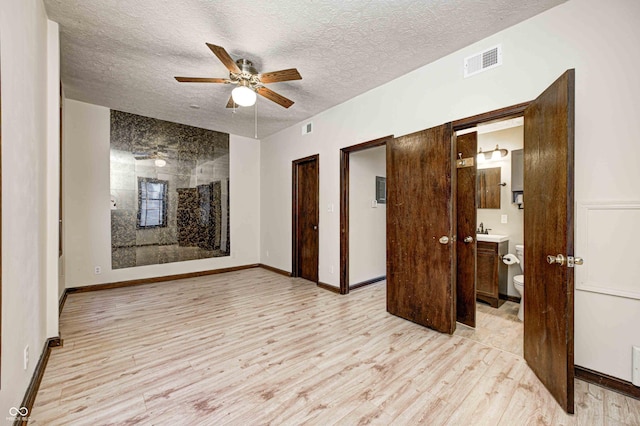 spare room featuring ceiling fan, sink, a textured ceiling, and light hardwood / wood-style flooring