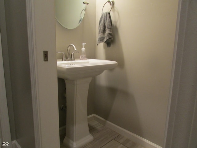 bathroom featuring baseboards and wood finished floors