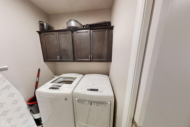 laundry room featuring cabinet space and separate washer and dryer