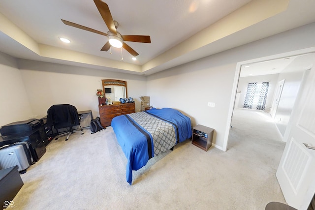 bedroom with carpet floors, recessed lighting, a raised ceiling, ceiling fan, and baseboards