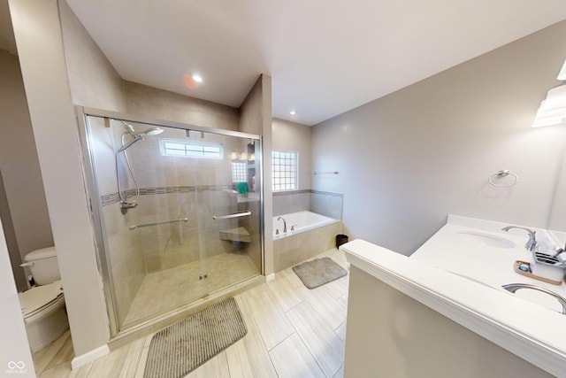 full bath with double vanity, toilet, a bath, a shower stall, and a sink