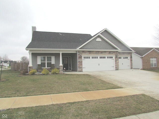 craftsman-style house with concrete driveway, stone siding, an attached garage, fence, and a front lawn