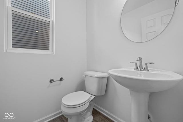 bathroom featuring hardwood / wood-style flooring and toilet