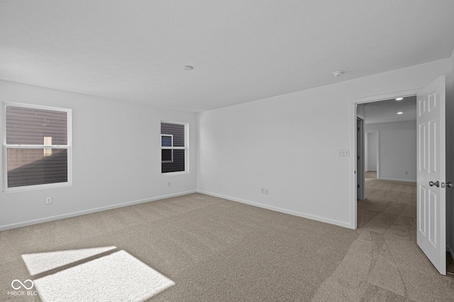 unfurnished room featuring light colored carpet