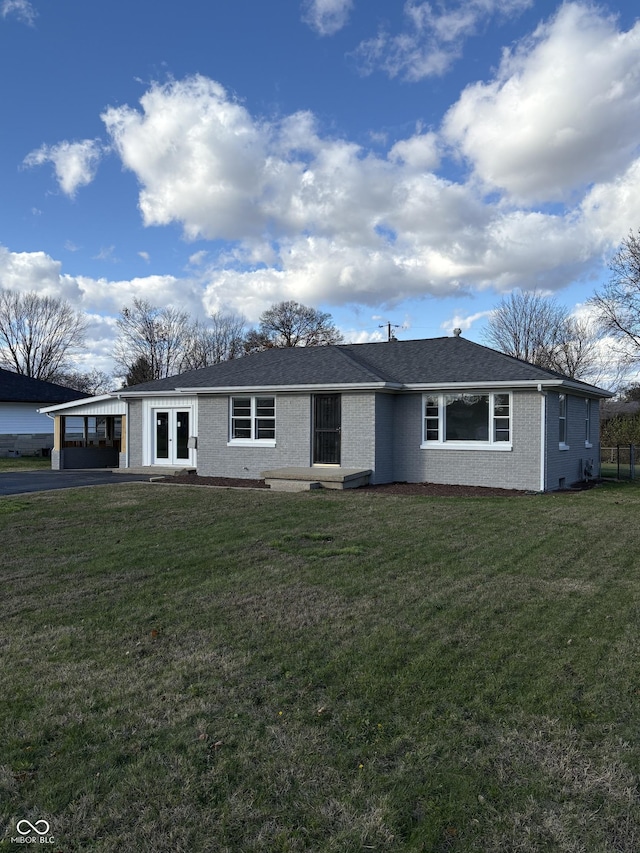 single story home with a front yard and french doors