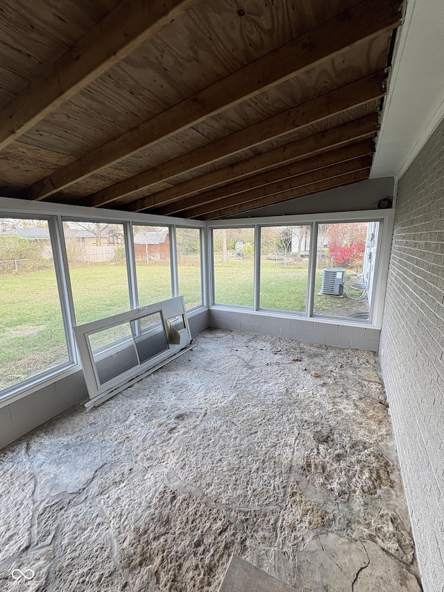 unfurnished sunroom featuring lofted ceiling with beams