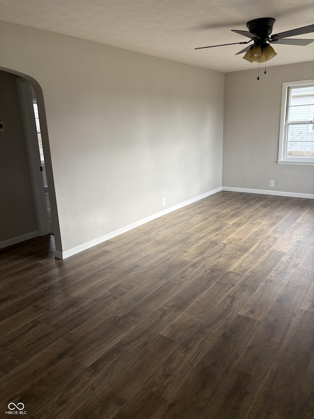 unfurnished room featuring a textured ceiling, dark hardwood / wood-style flooring, and ceiling fan