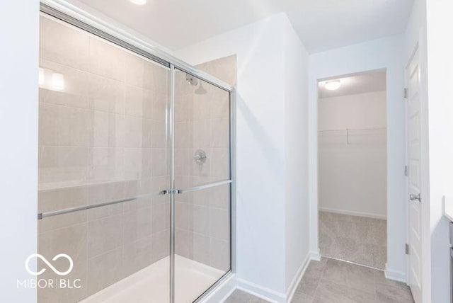 bathroom featuring tile patterned flooring, vanity, and a shower with door