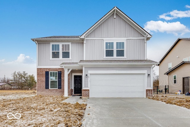 view of front of property with brick siding, driveway, and an attached garage