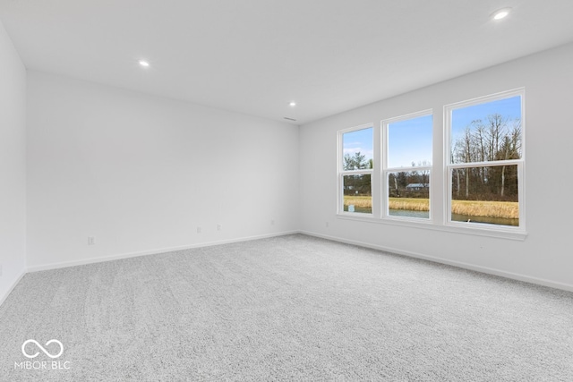 unfurnished room with recessed lighting, carpet flooring, and baseboards