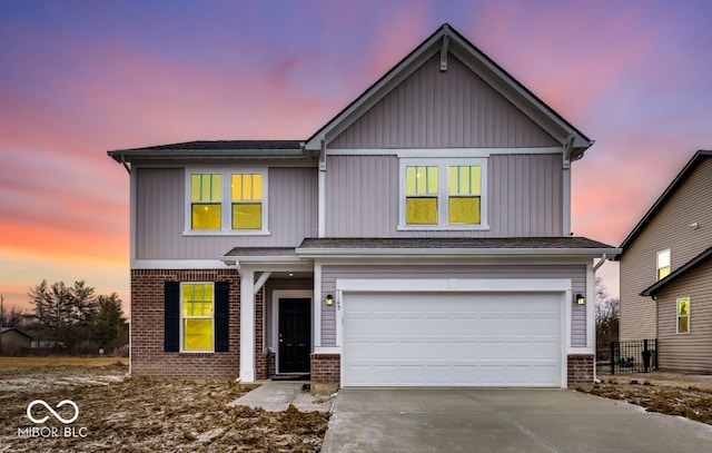 traditional-style house featuring driveway, brick siding, and an attached garage