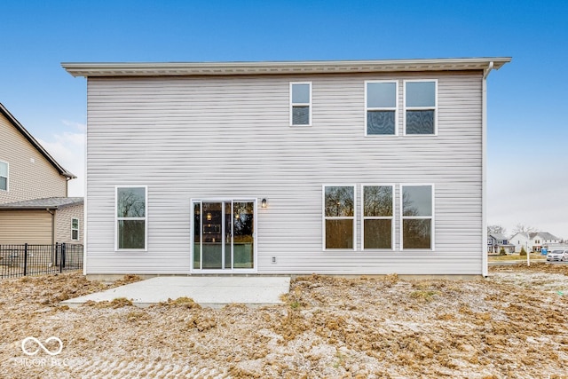 rear view of property with a patio and fence