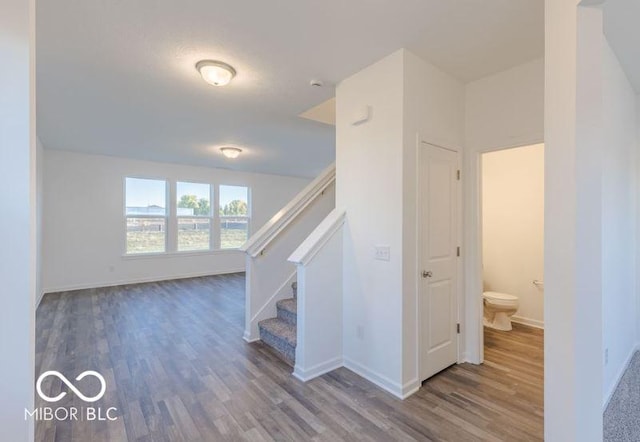 stairs featuring baseboards and wood finished floors