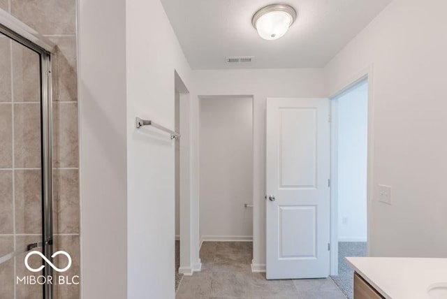 bathroom featuring a stall shower, visible vents, and vanity