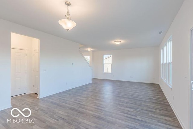 empty room featuring wood finished floors and baseboards