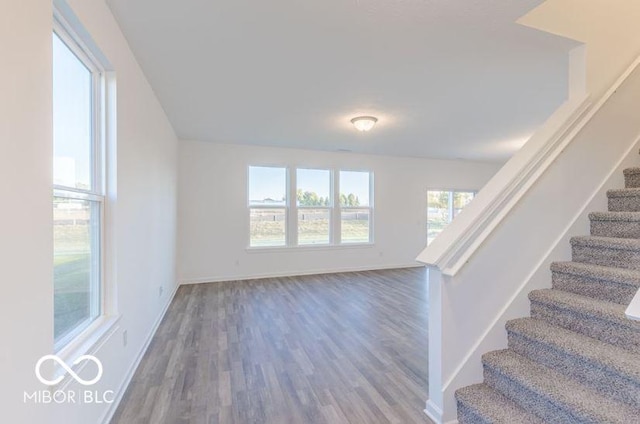 stairway with baseboards and wood finished floors