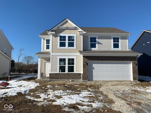 view of front facade with a garage and brick siding