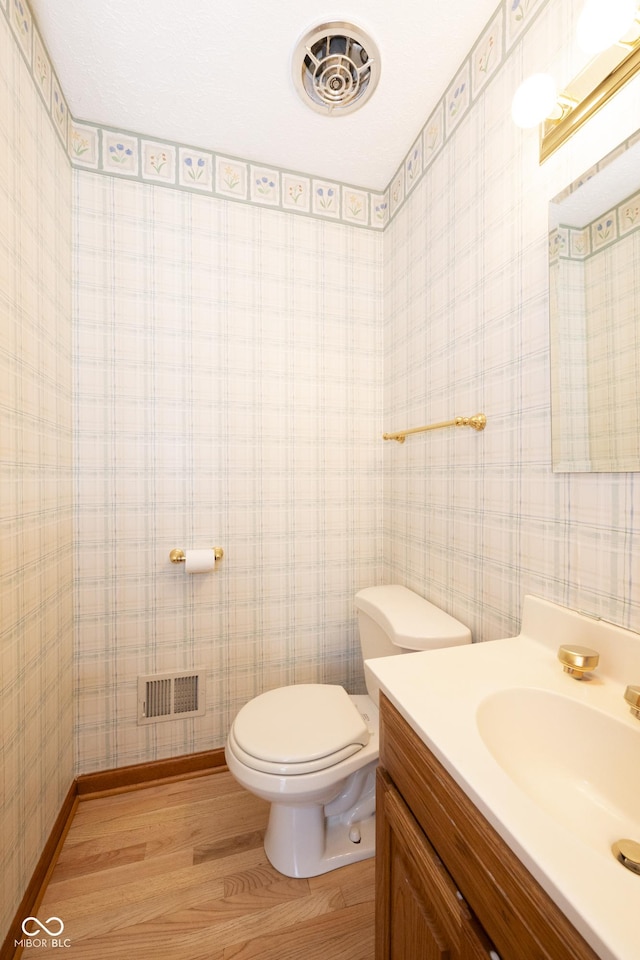 bathroom featuring hardwood / wood-style floors, vanity, and toilet