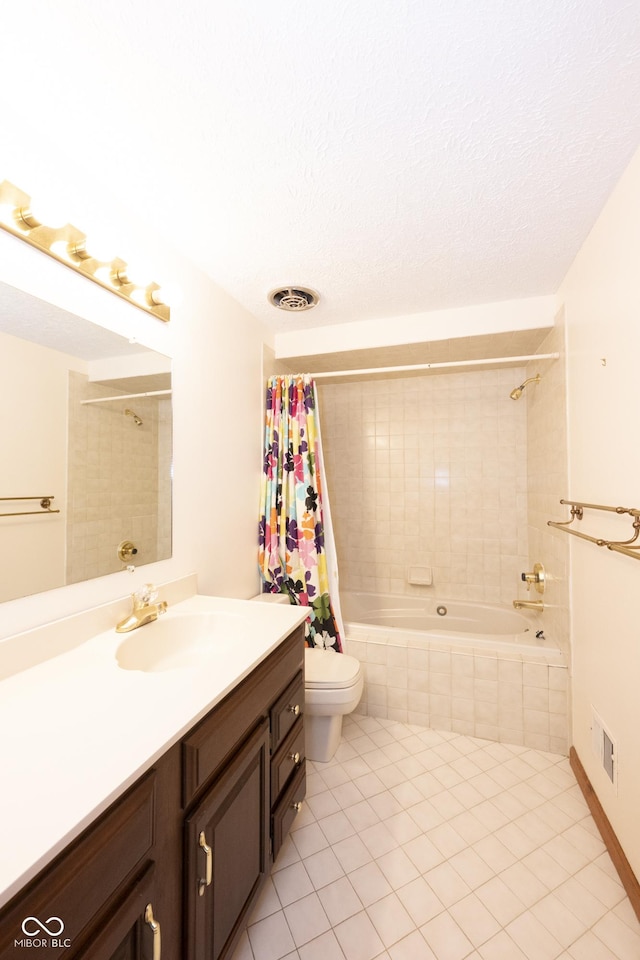 full bathroom with vanity, tile patterned flooring, toilet, a textured ceiling, and shower / tub combo