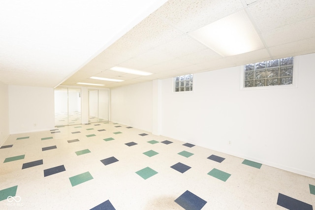 basement featuring a paneled ceiling