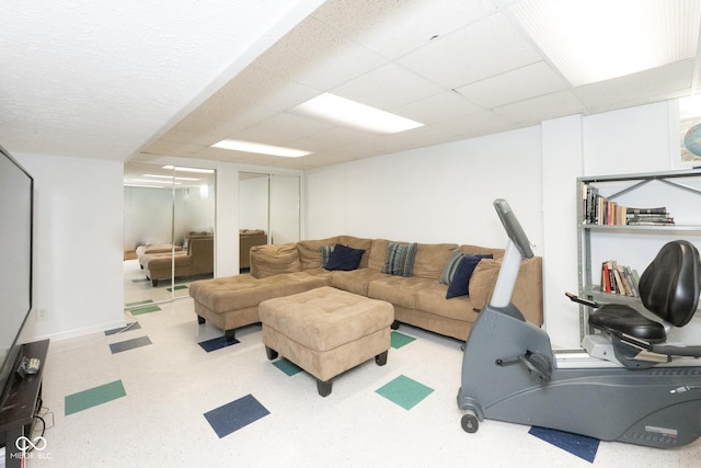 living room with a paneled ceiling