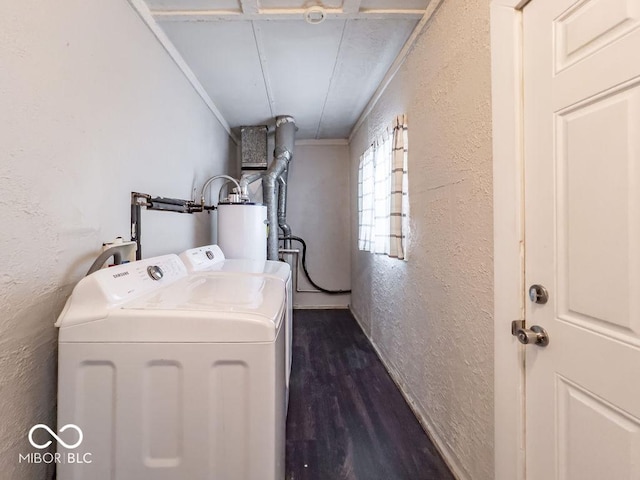 laundry area featuring water heater, dark hardwood / wood-style floors, and washer and dryer