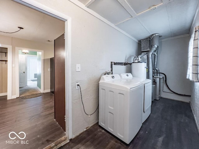 clothes washing area featuring separate washer and dryer, gas water heater, and dark wood-type flooring