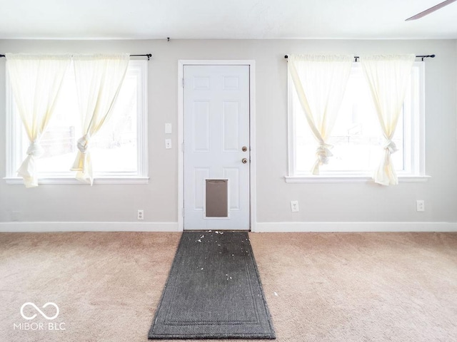 view of carpeted foyer entrance