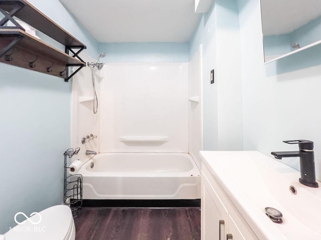 full bathroom featuring shower / bath combination, wood-type flooring, vanity, and toilet