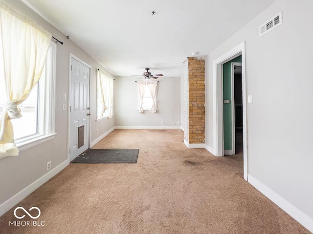 foyer entrance featuring ceiling fan, a healthy amount of sunlight, and carpet flooring