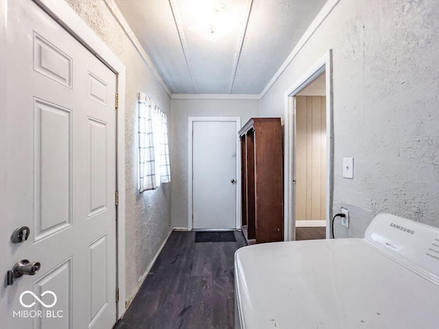 washroom with ornamental molding, dark hardwood / wood-style flooring, and washer / dryer