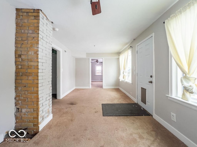 entrance foyer featuring light colored carpet and ceiling fan