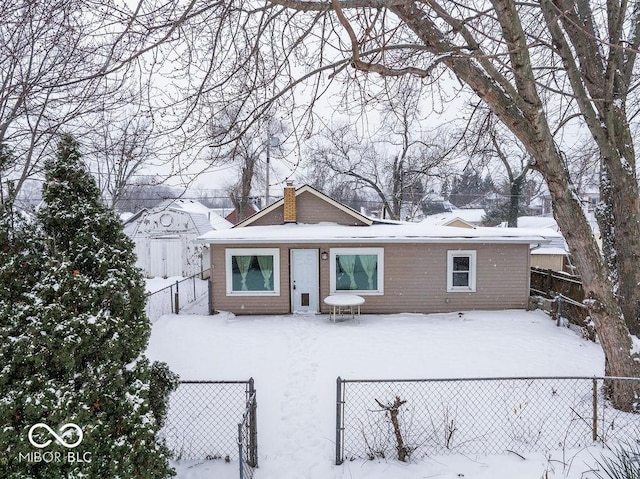 view of snow covered back of property