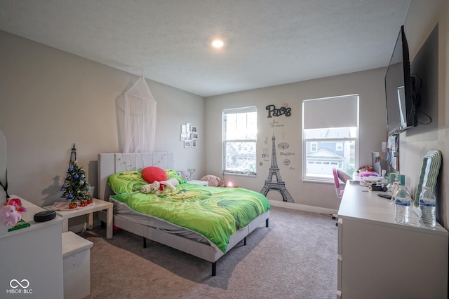 bedroom featuring carpet floors and a textured ceiling