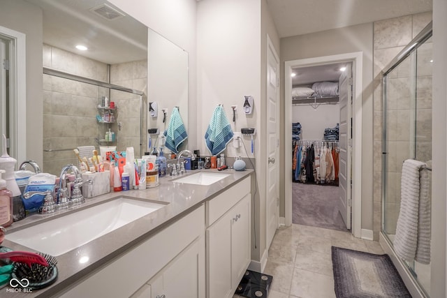 bathroom featuring vanity, tile patterned floors, and a shower with door