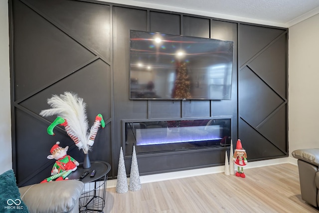 room details with crown molding, wood-type flooring, and a textured ceiling