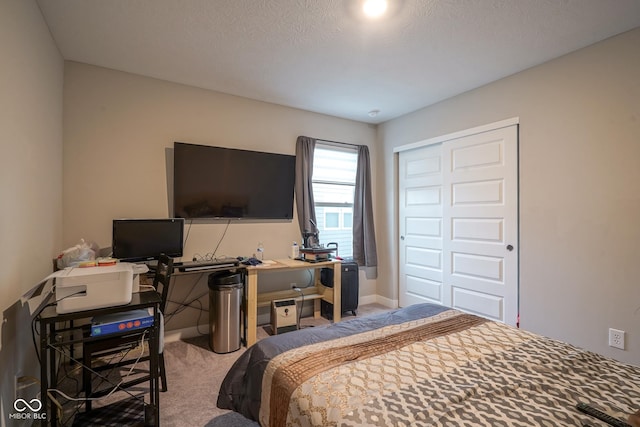 bedroom with a closet, carpet, and a textured ceiling