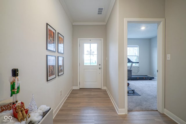 entryway featuring light hardwood / wood-style floors and crown molding