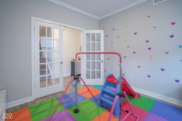 playroom with wood-type flooring and ornamental molding