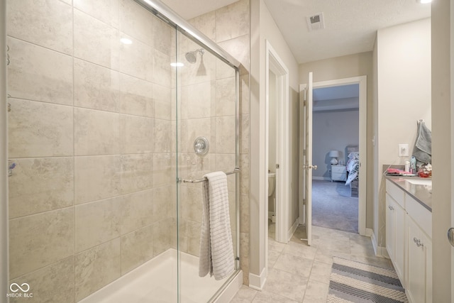 bathroom with vanity, toilet, and an enclosed shower