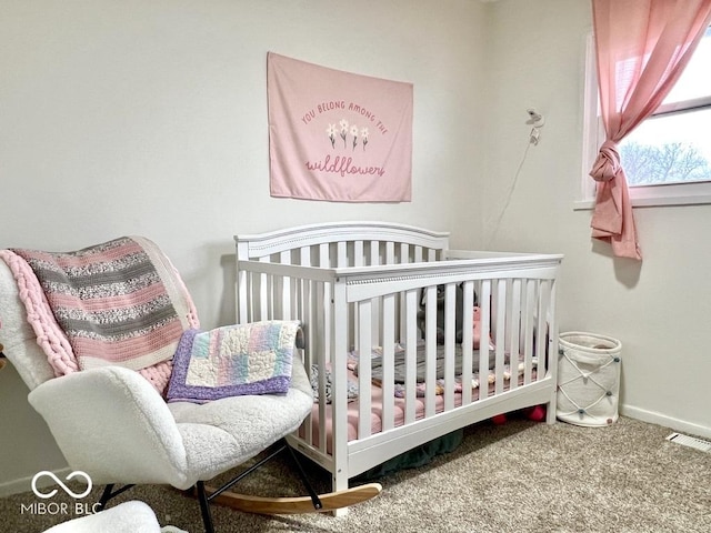 bedroom featuring carpet flooring and a nursery area